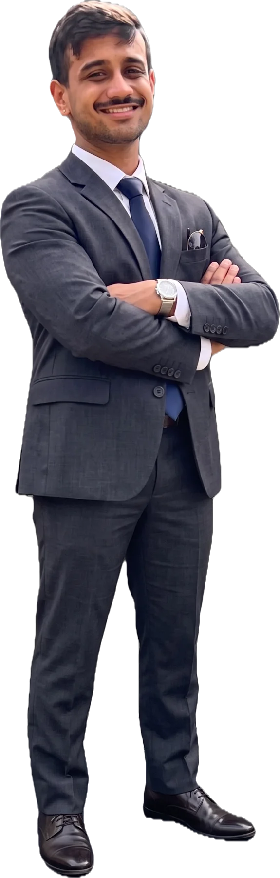 Mayukh Das, standing in a grey suit with arms crossed